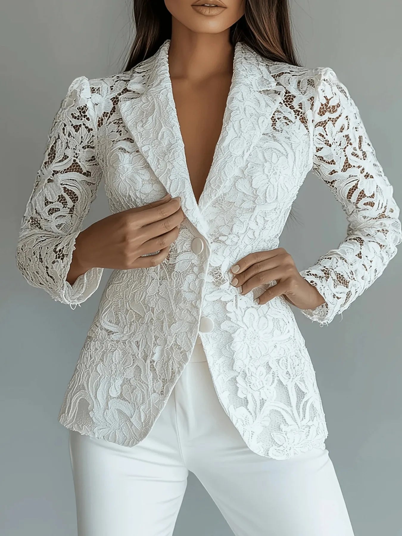 White lace blazer worn by a model on a gray background