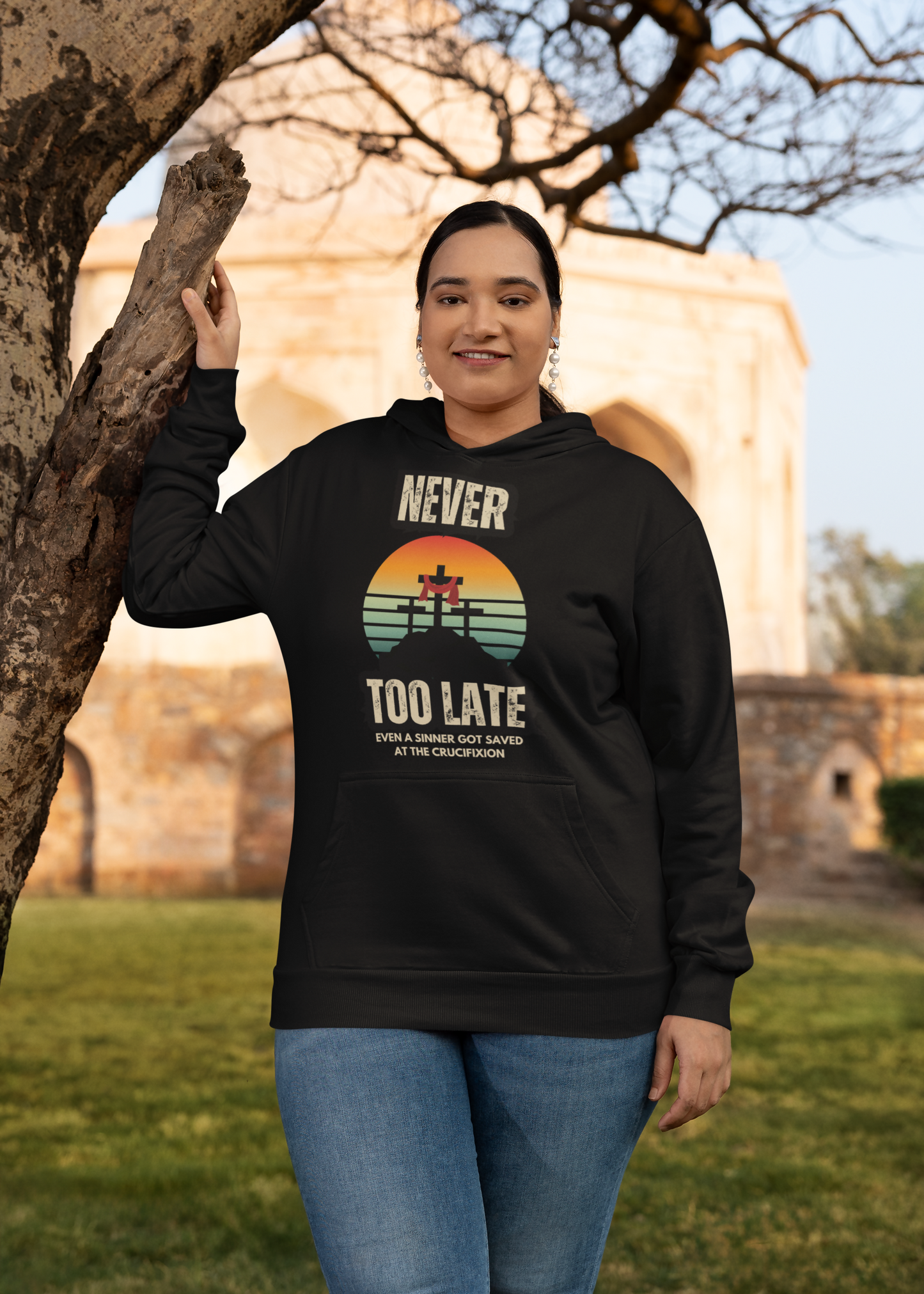 plus-size-gildan-pullover-hoodie-mockup-of-a-woman-standing-next-to-a-tree-m39616